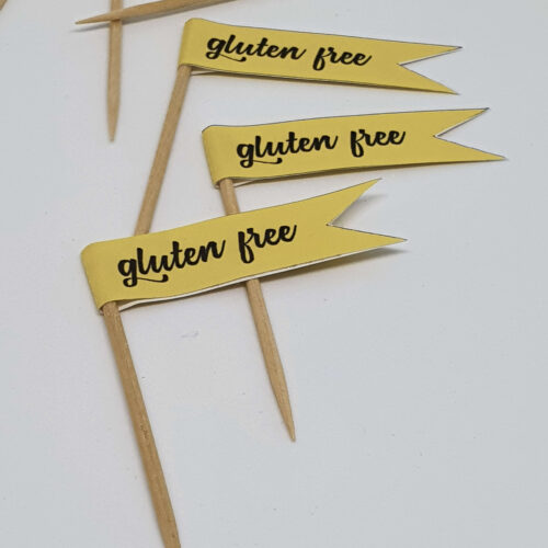Pastel yellow GLUTEN FREE toothpick food flags close up image